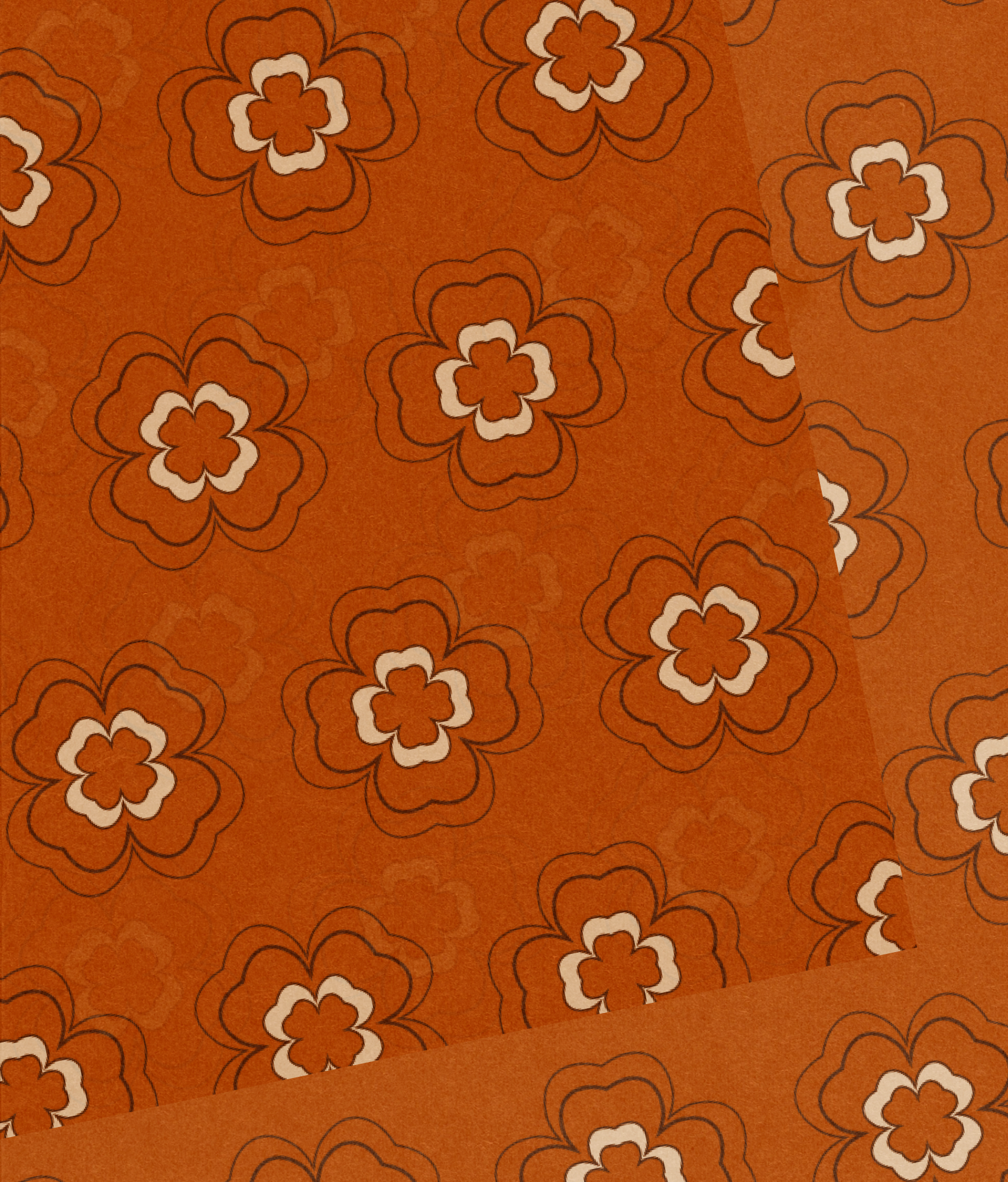 Layered sheets of tissue paper printed with a repeating retro flower