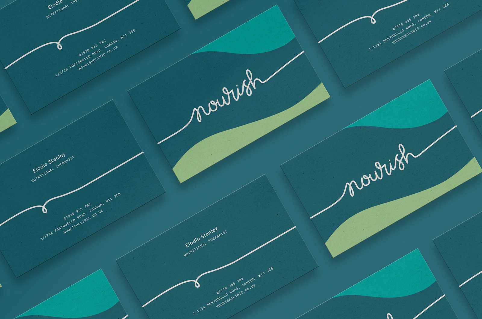 Nourish business cards tiled at an angle on teal, the script logo over a wave of green and the reverse carrying Elodie Stanley, nutritional therapist