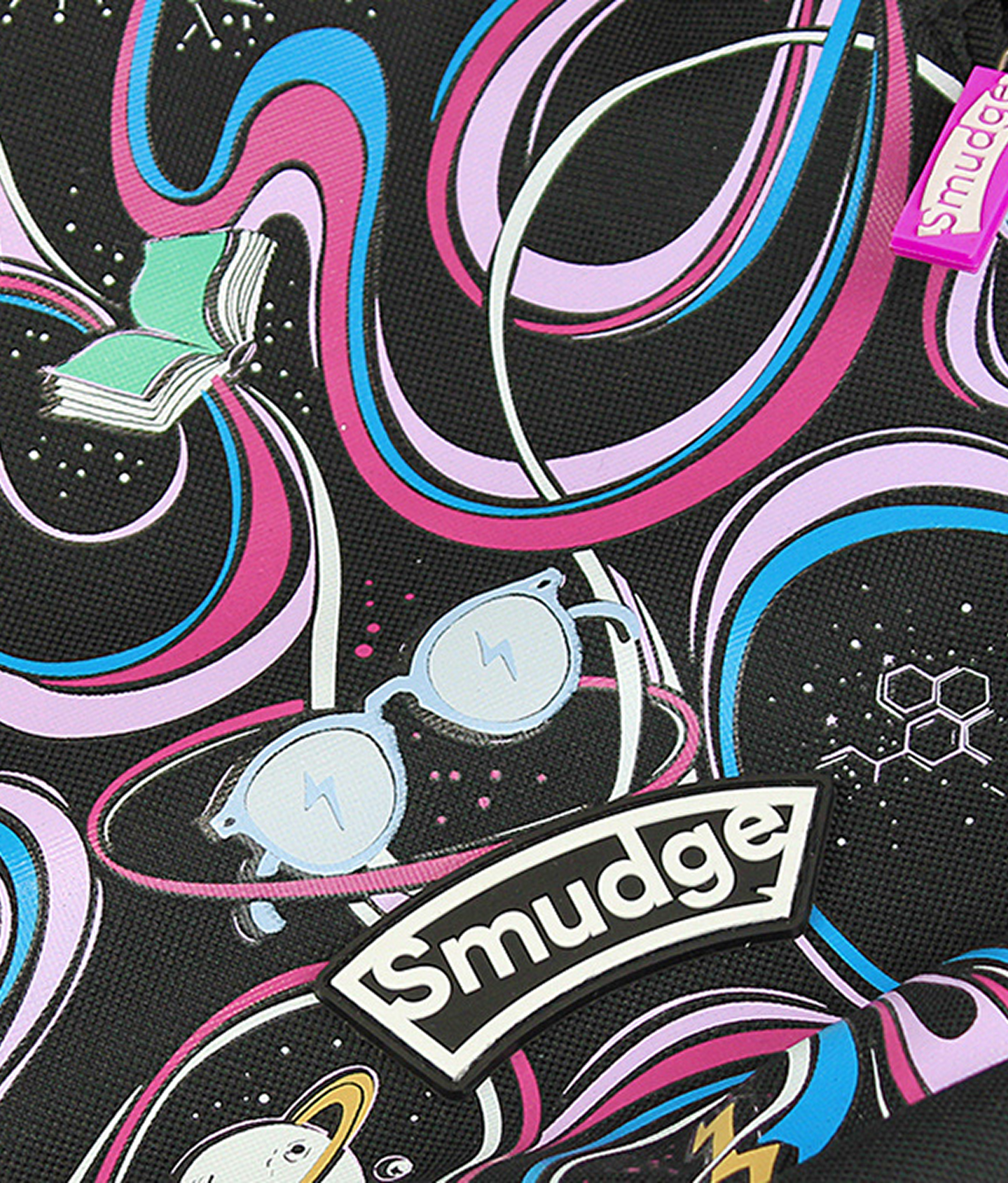 Close up of the backpack print, ribbons of pink and blue looping past a planet and a pair of glasses, with the rubber Smudge badge stitched on